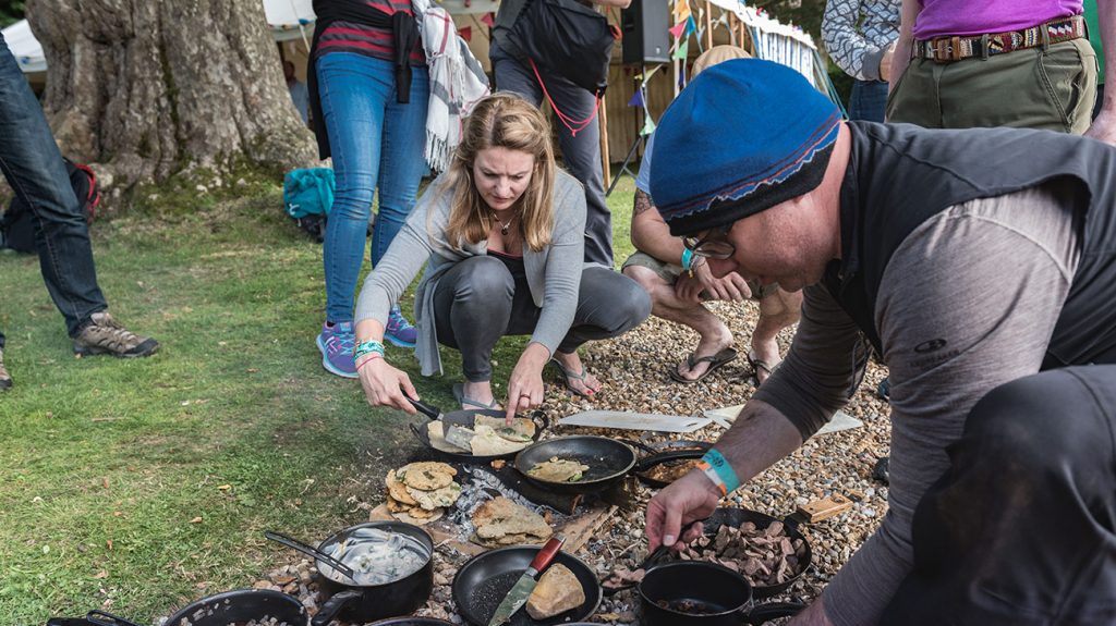 Keran Creevey cooking on a camfire at the Adventure Travel Film Festival