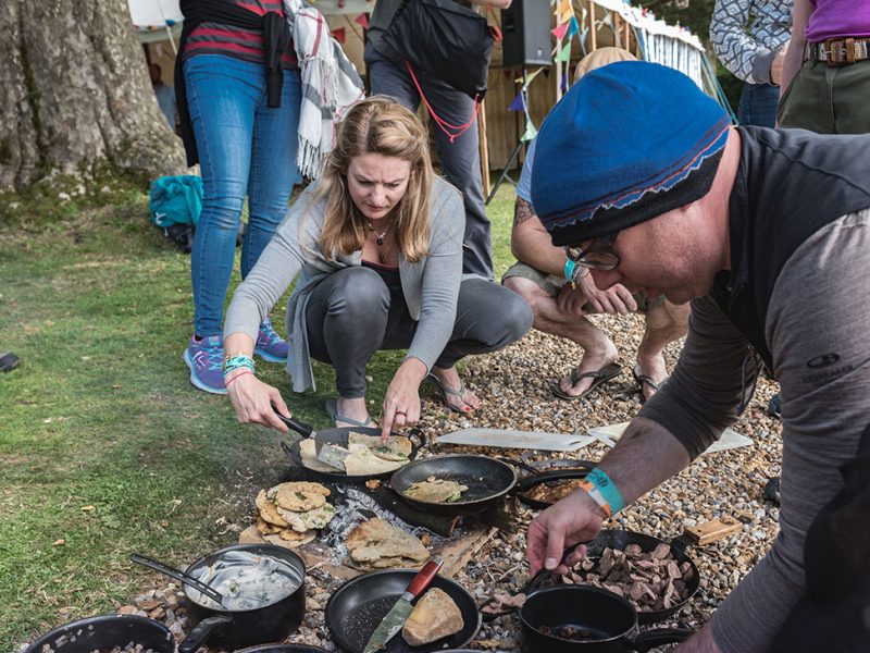 Keran Creevey cooking on a camfire at the Adventure Travel Film Festival